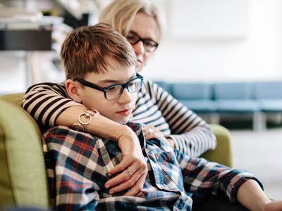 Mother and son sitting on a couch together