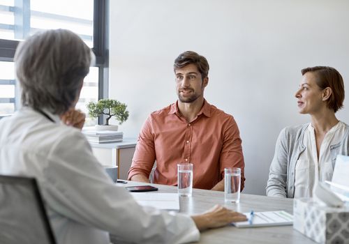 Couple talking to a doctor about fertility treatments