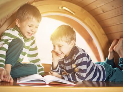 Little boys having fun reading.