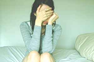 A woman covering her face