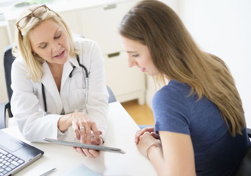 Doctor talking to patient in office