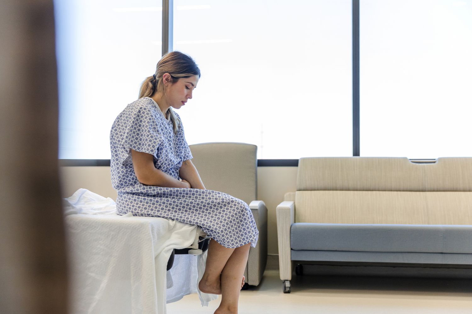 Pregnant person considers the dilation and curettage she's about to undergo