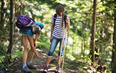 Mother applying tick repellent on daughter