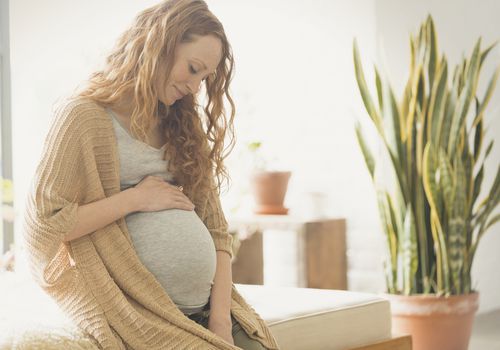 Pregnant woman holding stomach