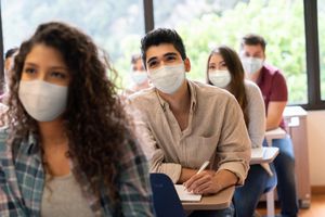 people in classroom wearing masks