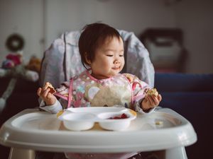 可爱的小宝宝独自享受早餐