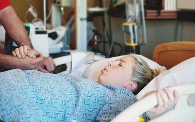Young woman enduring labor pains in hospital