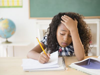 Frustrated young student working in classroom