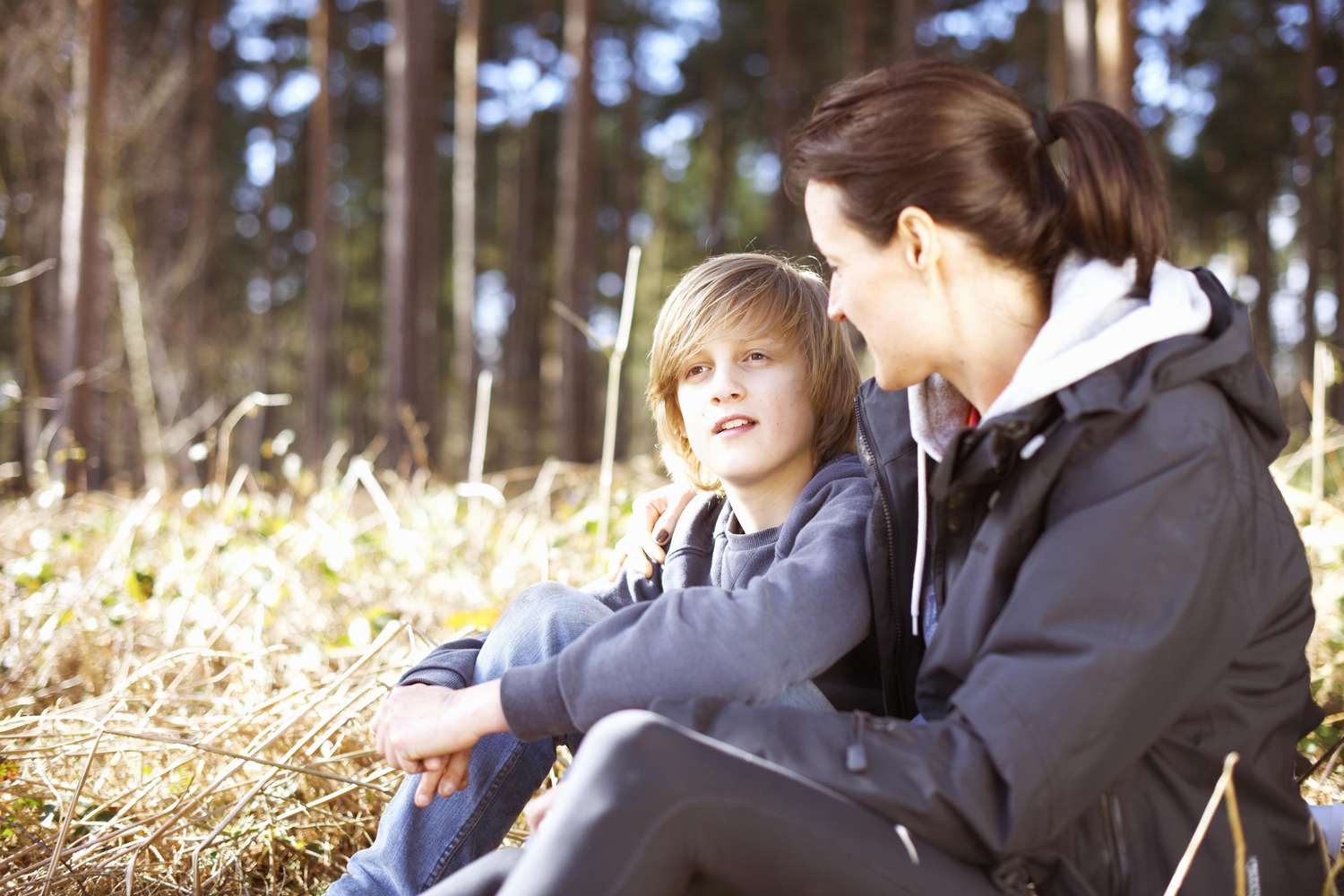 Mature woman taking a break with her son in a forest