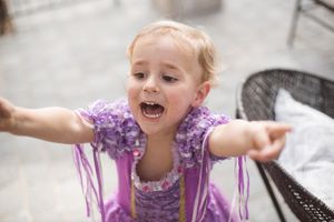 excited kid dressed in princess dress