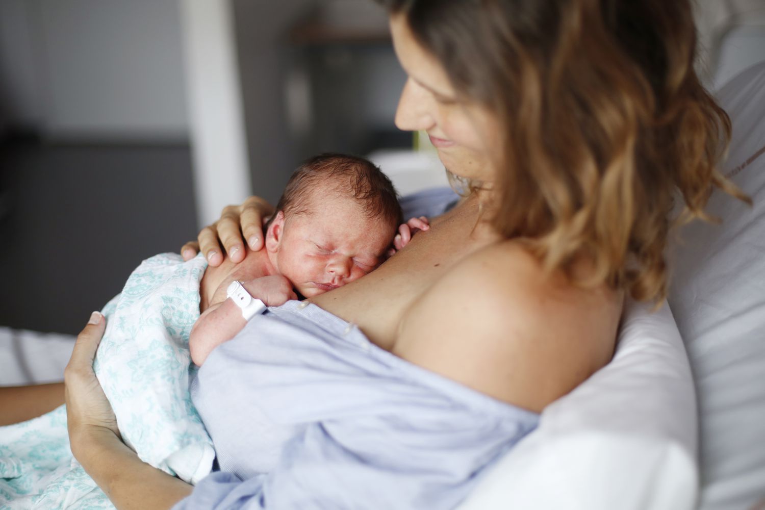 A newborn and his mother at maternity ward
