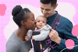 Parents holding baby in a carrier