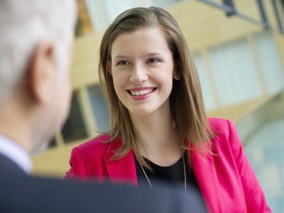 Business executives discussing in an office corridor.