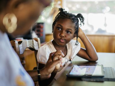 Young girl gets help at school