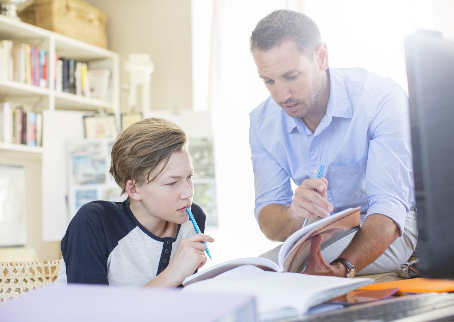 Father helping son with schoolwork