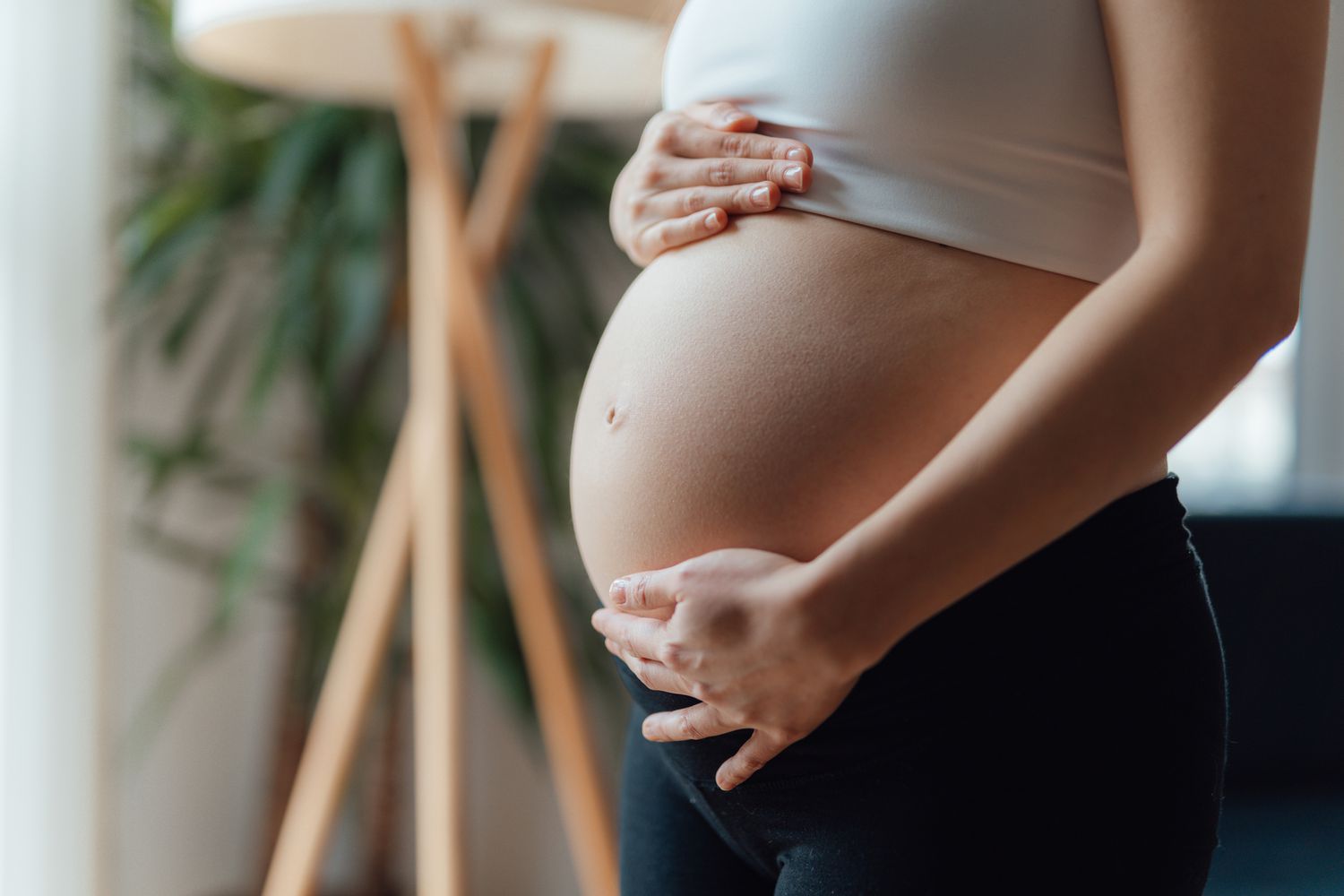 Pregnant woman holding belly