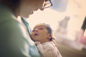 Mom smiling at newborn