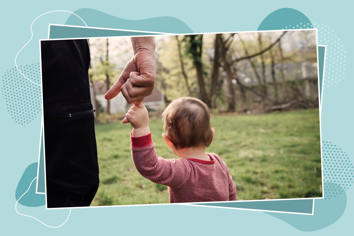 Baby holding dad's hand