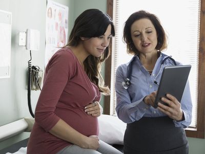 A doctor and a pregnant patient.