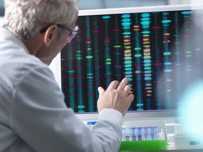 Scientist comparing DNA results on a computer screen in the laboratory