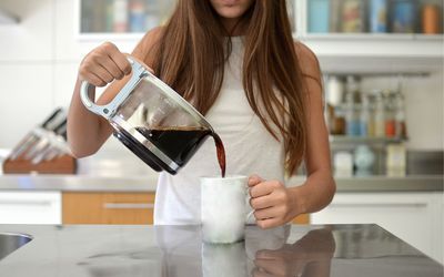 Teenager pouring themselves a cup of coffee