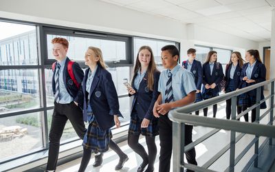 Students in uniforms walking to class.
