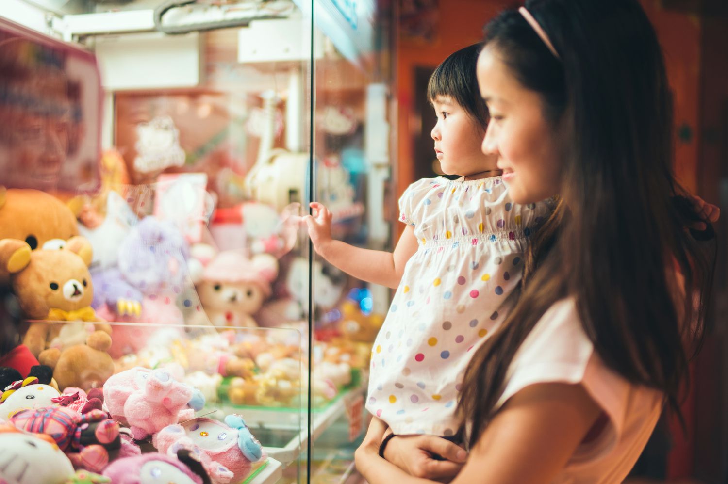 Mother and child looking at toys