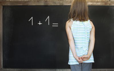 A girl struggles with a math problem.