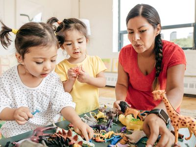 woman playing with two kids
