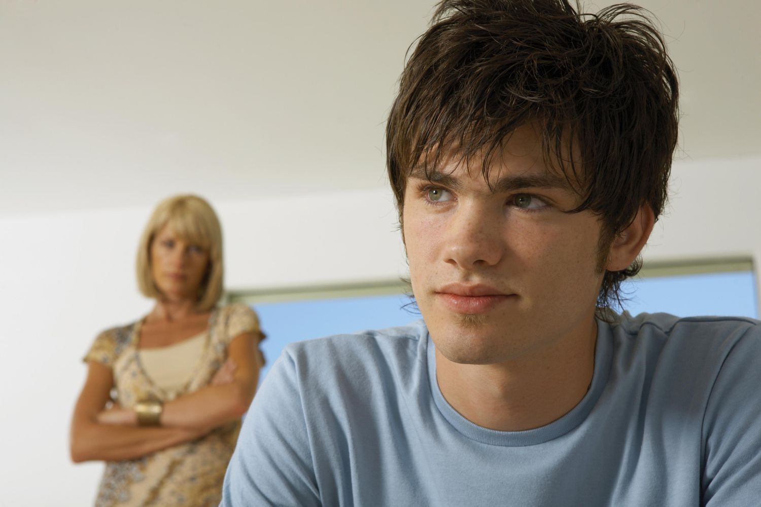 Boy upset, mother in the background
