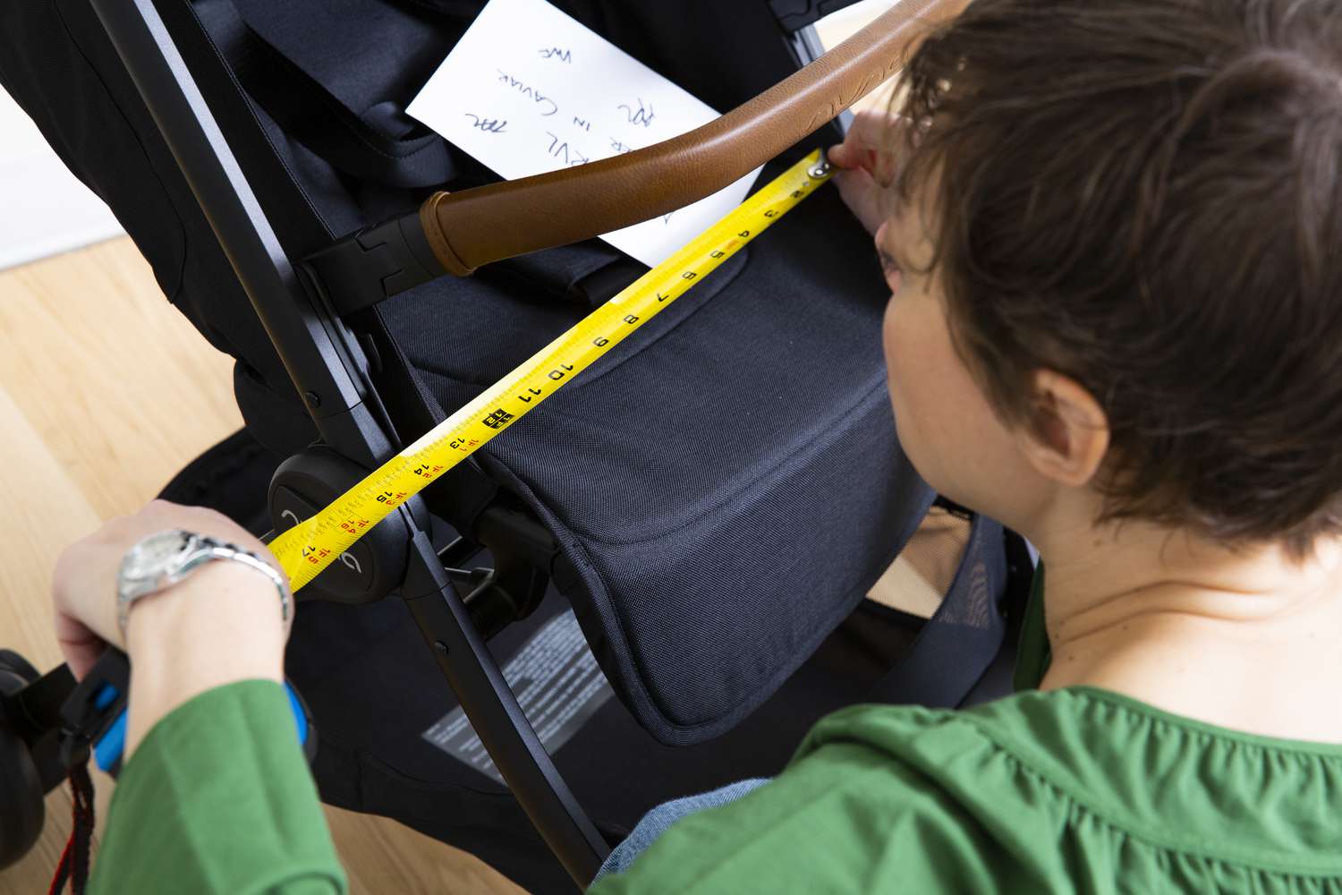 Person measuring the Nuna TRVL Stroller