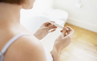 Woman Checking Pregnancy Test Kit