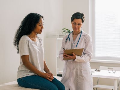 Patient talking to their doctor about how to check their cervix