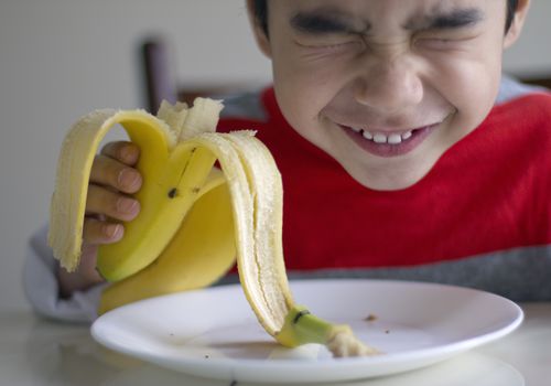 Boy eating banana
