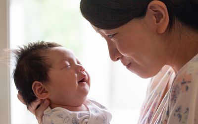 Mom holding baby's head up