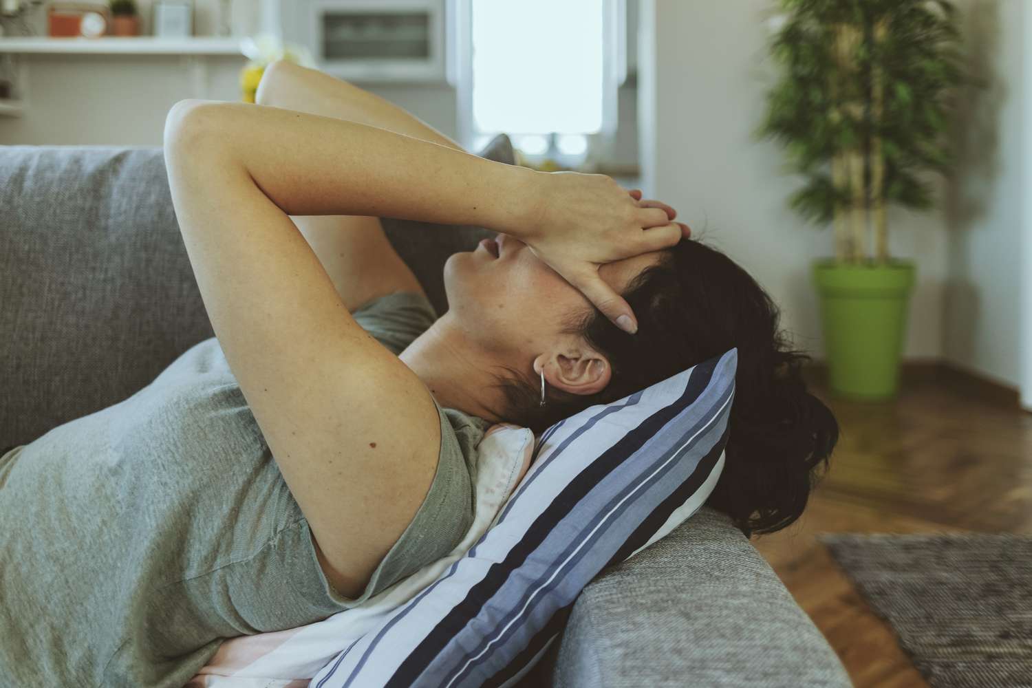 pregnant woman holding her head in her hands
