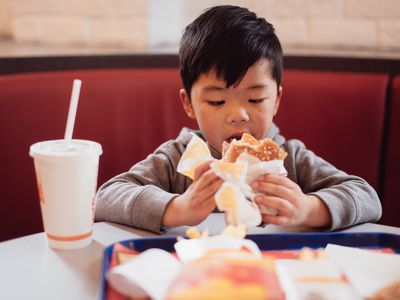 A boy eating at a fast food restaurant