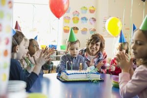 Teacher and children celebrating birthday in school