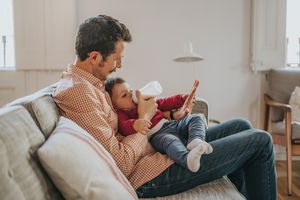 Father feeds baby lactose-free formula from bottle