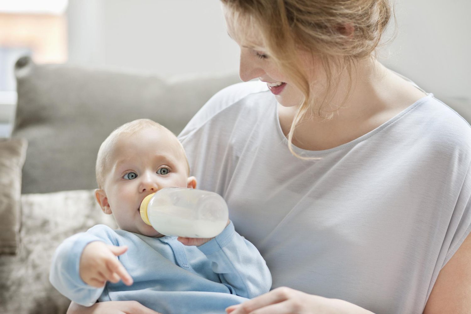 Baby girl feeding on milk with a milk bottle.