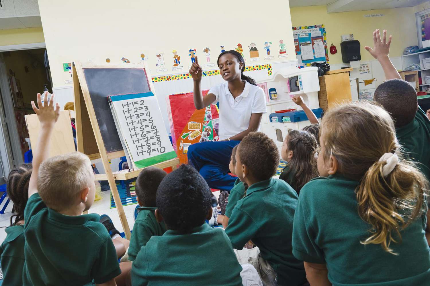 Teacher with preschool students in classroom.