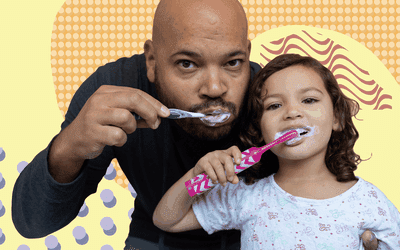 Father and daughter brushing their teeth