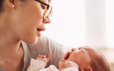 Mom calming a crying baby in her arms
