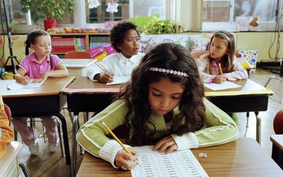 Schoolchildren (6-11) doing arithmetic in class
