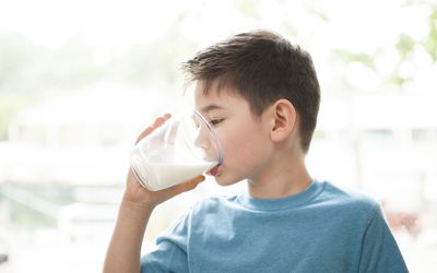 Young boy drinking milk