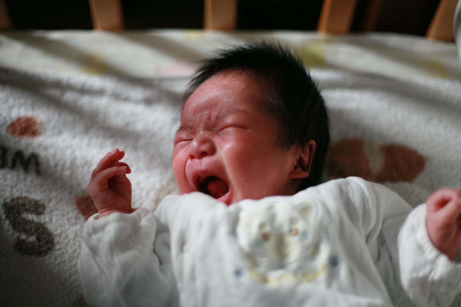 A baby crying in their crib
