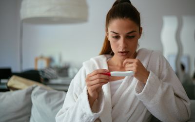 Worried person looking at a pregnancy test