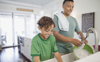 father and son doing dishes