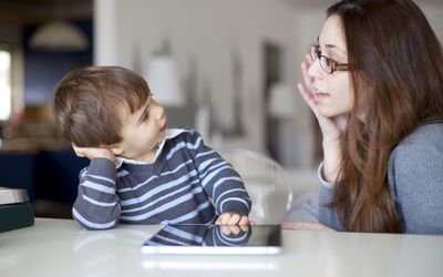 Small boy talking to his mother
