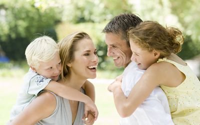 family smiling at each other, happy, outdoors